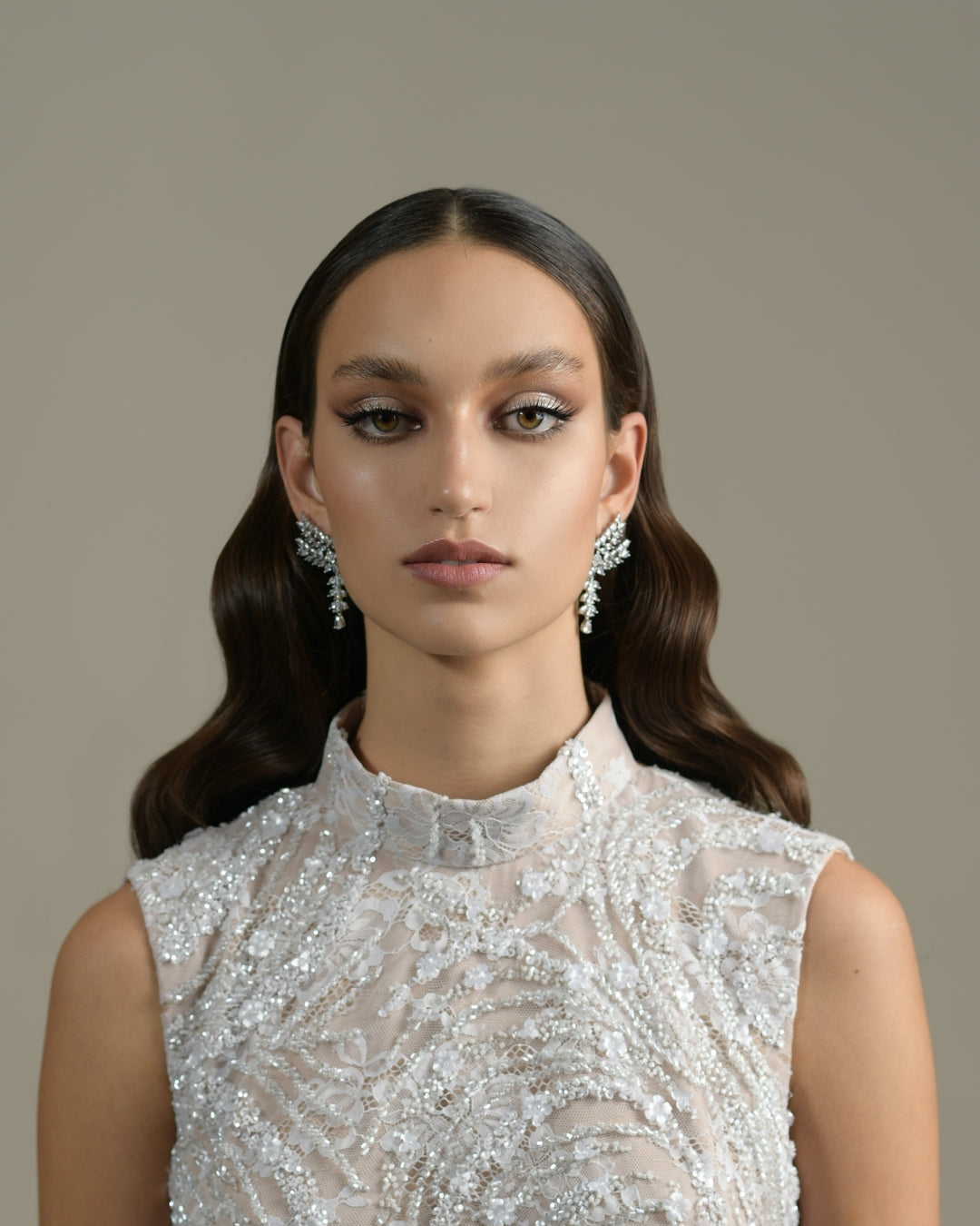 Soft bridal waves with centre part and crystal earrings. Wedding hairstyling by HAIR ETC. STUDIO Nicosia Cyprus